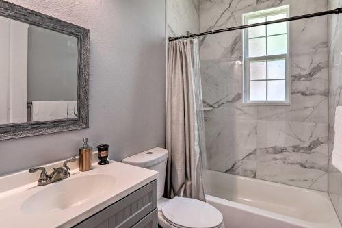 a bathroom with a sink and a toilet and a shower at St Pete Escape with Patio and Yard 6 Mi to Beach in St Petersburg