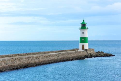 a lighthouse on an island in the ocean at Hotel Zur Mühle in Kappeln