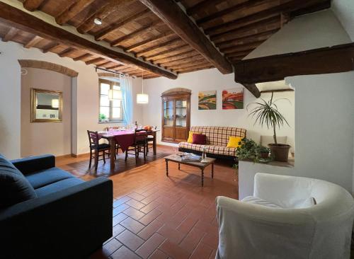 a living room with a couch and a table at CASA PARTINGOLI in Pian dei Cerri