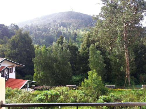 a view of a mountain from a house at Maple View in Ooty