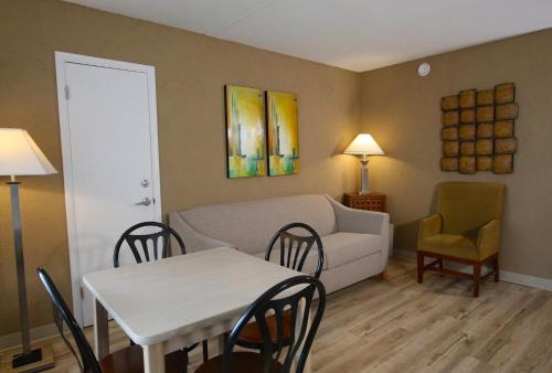a living room with a table and a couch at Crusader Oceanfront Resort in Wildwood Crest
