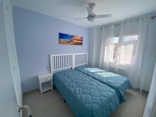 ein blaues Schlafzimmer mit einem Bett und einem Fenster in der Unterkunft Casa en Begur reformada in Begur
