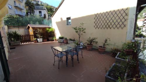 a patio with a table and chairs in a courtyard at I love Rapallo La casa AlMar in Rapallo