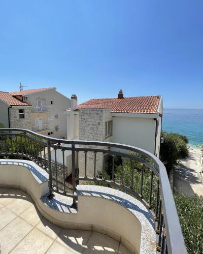 a stairway leading to a balcony overlooking the ocean at Villa ARINA - Apartments 20 m from Beach, Tucepi in Tučepi