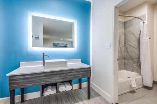 a bathroom with a sink and a bath tub at Americas Best Value Inn & Suites Houston at Hwy 6 in Houston
