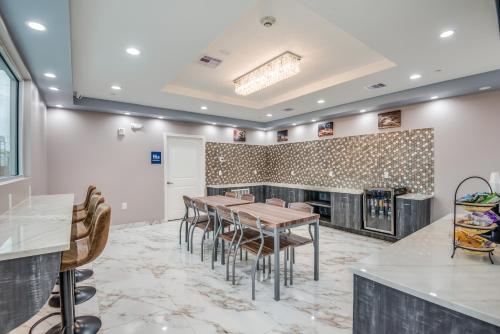 a dining room with tables and chairs and a fireplace at Americas Best Value Inn & Suites Houston at Hwy 6 in Houston
