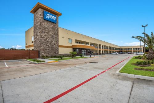 a large building with a blue sign on it at Americas Best Value Inn & Suites Houston at Hwy 6 in Houston