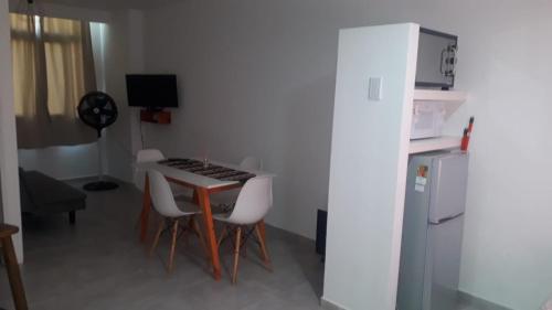 a small kitchen with a table and chairs and a computer at Depto Temporario La Plata in La Plata