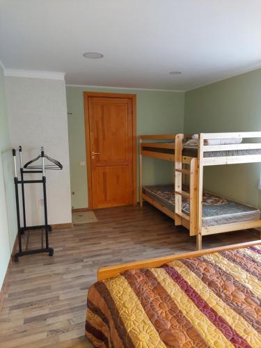 a room with two bunk beds and a door at Brīvdienu māja Saulīte in Ventspils