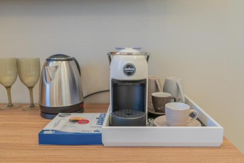a coffeemaker sitting on top of a table at Le Suite in Crotone