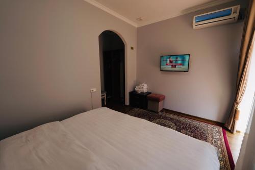 Un ou plusieurs lits dans un hébergement de l'établissement Samarkand Travel