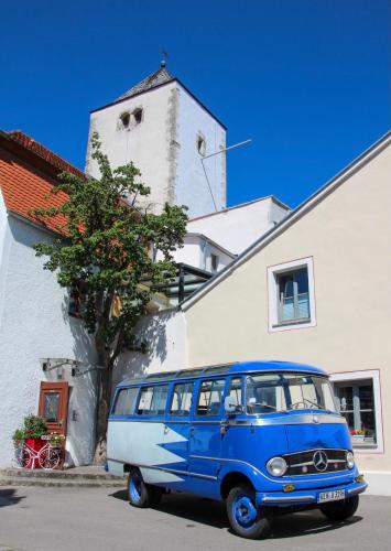 a blue van parked in front of a building at Turmhotel zum Erasmus in Kelheim