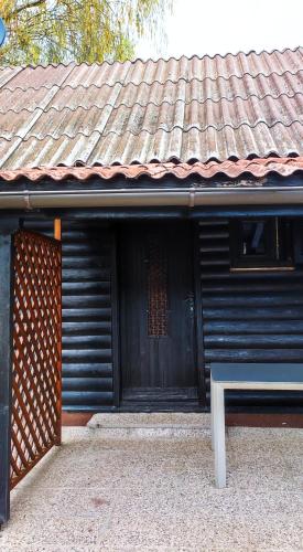 a building with a bench in front of a door at Hiška Čatež in Brežice