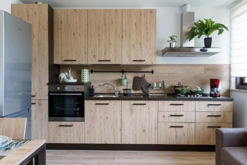 a kitchen with wooden cabinets and a sink at Itaca in Lido di Fermo