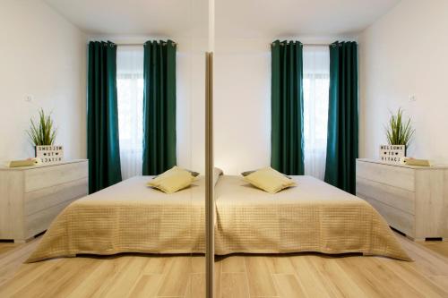 a bedroom with a bed with green curtains at Itaca in Lido di Fermo