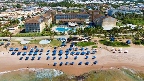 an aerial view of a beach with chairs and umbrellas at Gran Hotel Stella Maris Urban Resort & Conventions in Salvador