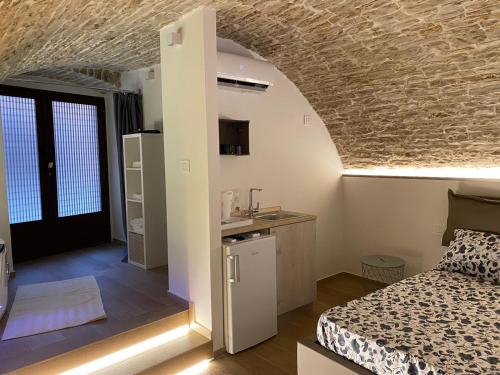 a bedroom with a bed and a kitchen with a sink at Suite Spa of Dreams in Bitonto