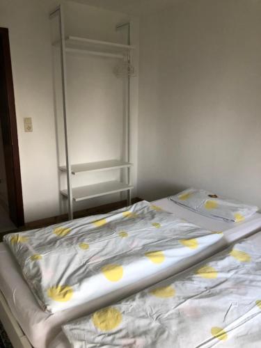 a bed with yellow flowers on it in a room at Appartement Rosengarten in Wachtberg