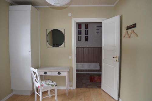 a room with a table and a chair and a mirror at Hazel Ridge in Hudiksvall