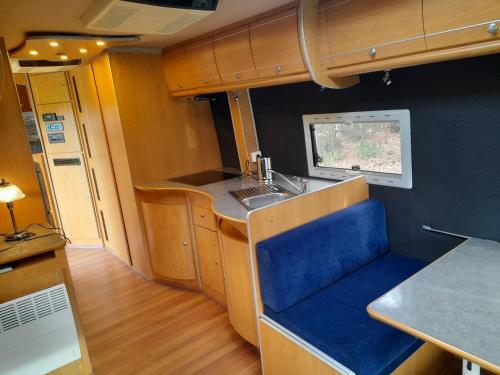 an rv kitchen with a sink and a counter at Kromven On Wheels in Merksplas