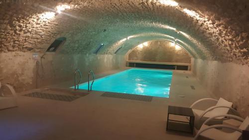 a swimming pool in a cave with a tunnel at Château de Jallanges & Spa à Vouvray - 1h de spa incluse par jour in Vouvray