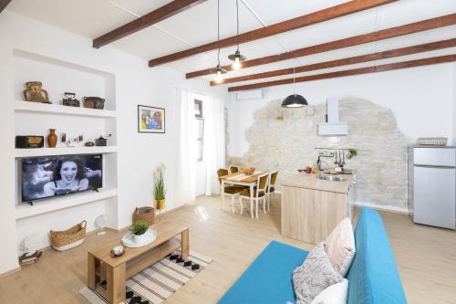 a kitchen and living room with a stone wall at Apartments Mario in Pula