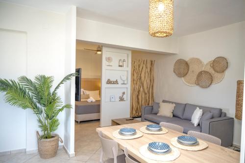 a living room with a table and a couch at Aegean Suite in Azolimnos Syros