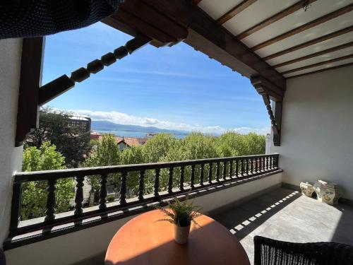a balcony with a table and a view of the mountains at Hotel Royal Suite Santander in Santander