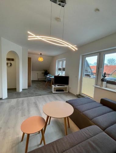 a living room with a couch and a table at Inselwohnung Nordstrand in Nordstrand