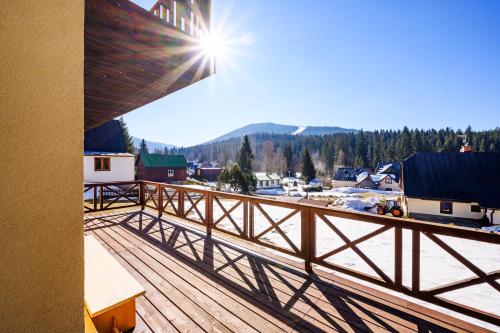 a balcony with a view of a snow covered mountain at Penzion Petra, Harrachov in Harrachov