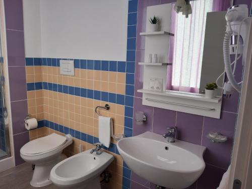 a bathroom with a toilet and a sink at B&B Costa Sicula in Avola