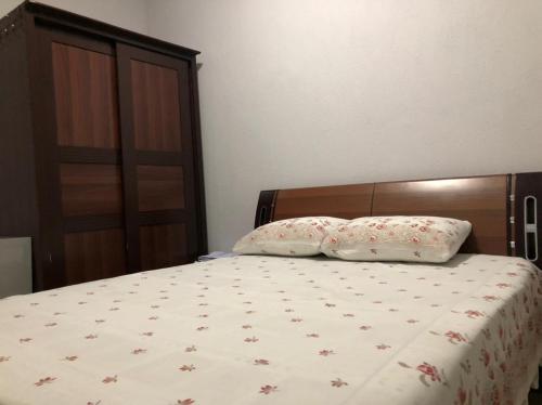 a bedroom with a bed with two pillows on it at Vila Vadeha in Pogradec