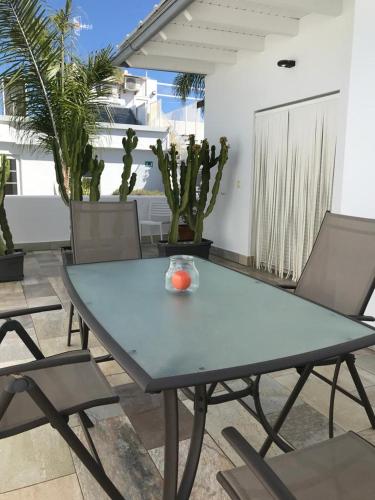 a blue table and chairs on a patio at Chipibeach B&B, Hostal Boutique in Chipiona