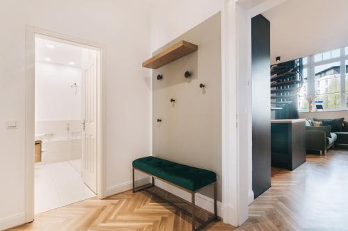 a hallway with a green bench in a white room at TIP! Modernes 90 qm City-Apartment mit Stil & Komfort in Toplage in Dresden