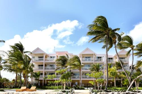 a hotel on the beach with palm trees at Grassy Flats Resort & Beach Club in Marathon