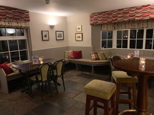 a living room filled with furniture next to a window at The White Hart Inn in Newbury
