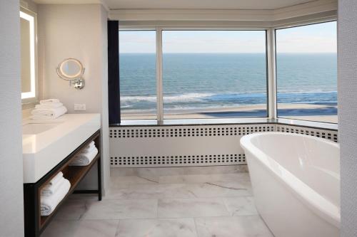 a bathroom with a tub and a large window at Bally's Atlantic City Hotel & Casino in Atlantic City