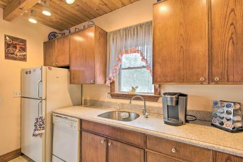 a kitchen with a sink and a refrigerator at Idyllic Lakefront Escape with Fire Pit and Grill! in Freedom