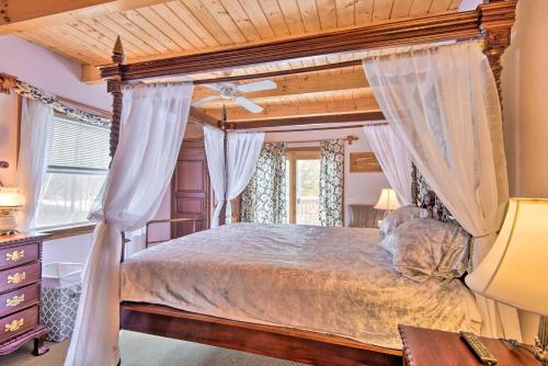 a bedroom with a canopy bed and a window at Idyllic Lakefront Escape with Fire Pit and Grill! in Freedom