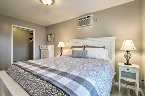 a bedroom with a bed and two lamps and a window at Centrally Located South Hill Apartment with Smart TV in Spokane