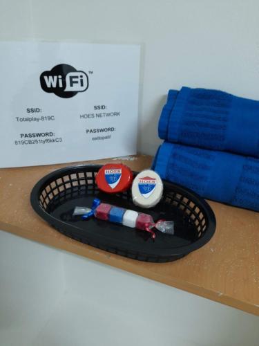 a basket of pens and toothbrushes on a counter at Special HOEStel in Monterrey! in Monterrey