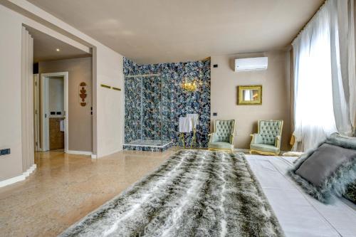 a bedroom with a bed and a large rug at Prestige Suite Sirmione in Sirmione