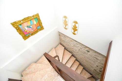 a staircase in a house with a painting on the wall at Prestige Suite Sirmione in Sirmione