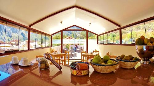 a dining room with a table with fruit on it at Kamma Guest House in Ollantaytambo