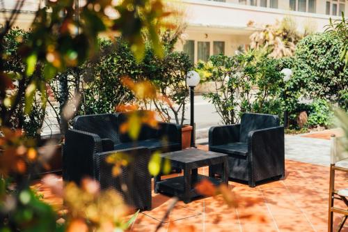two chairs and a table on a patio at Arcangelo Roof Hotel in Rimini