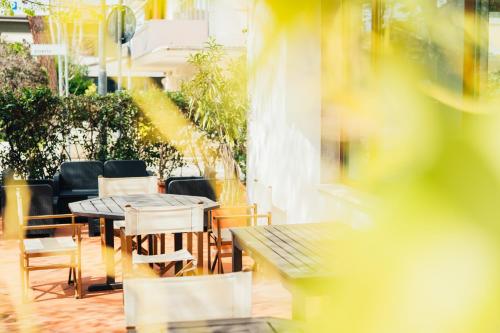 a table and chairs sitting on a patio at Arcangelo Roof Hotel in Rimini
