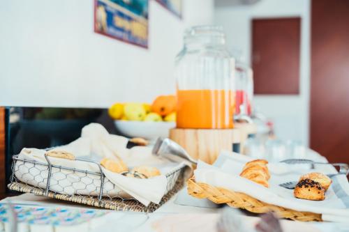 a table with bread and a bottle of orange juice at Arcangelo Roof Hotel in Rimini
