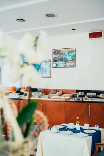 a table with blue dishes on it in a restaurant at Arcangelo Roof Hotel in Rimini