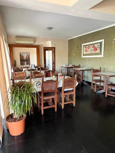 a dining room with wooden tables and chairs at Hotel Terrazas del Sol in Villa Carlos Paz
