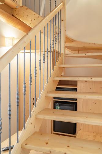 a staircase in a log home with wooden steps at Agriturismo Ortesida in Morbegno